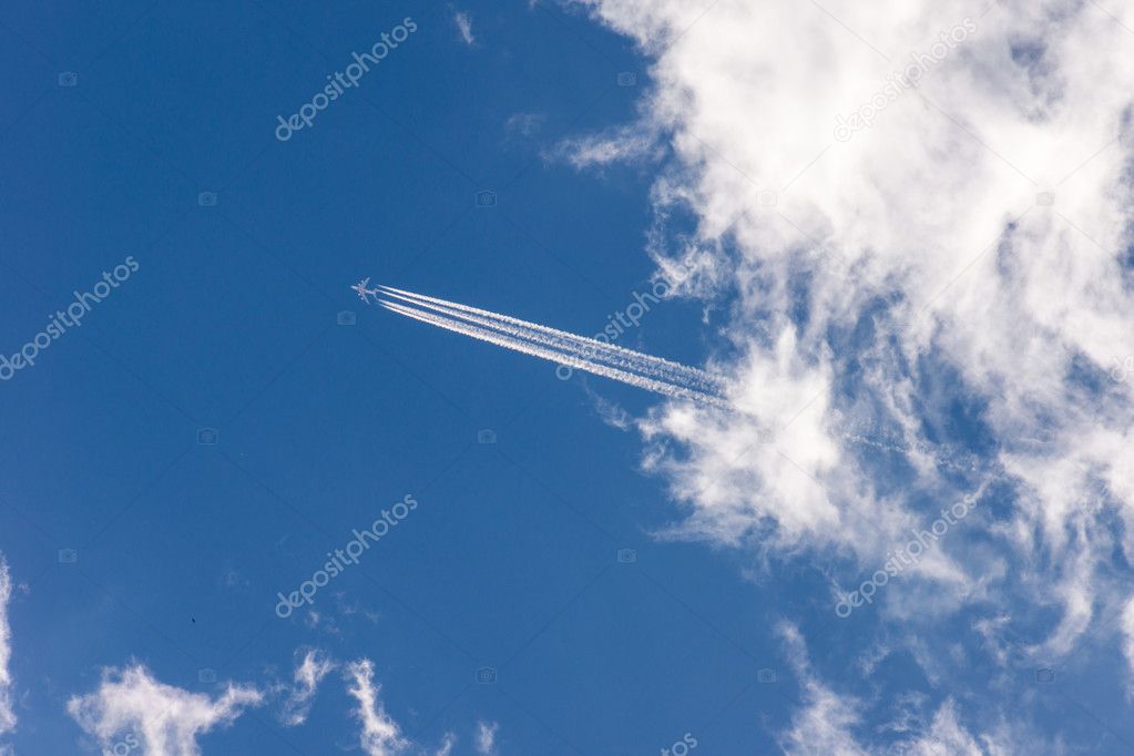 Aircraft flying high in the blue sky