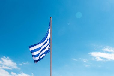 Greece national flag blowing open at top of pole