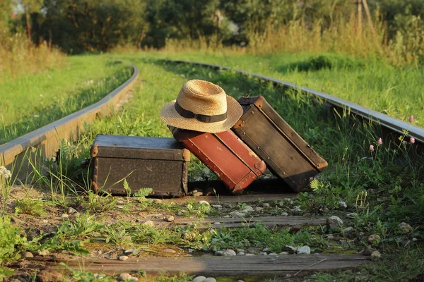 suitcases old  on railway tracks