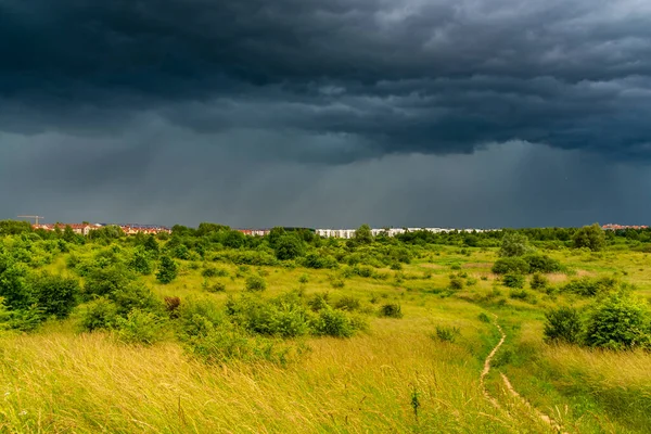 Dramatic view of a shelf cloud over a field, horizontal cloud formation, panorama view.