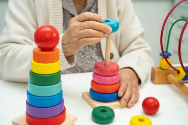 Asyalı yaşlı bir kadın, geliştirme oyunu oynuyor..