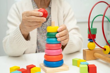 Asyalı yaşlı bir kadın, geliştirme oyunu oynuyor..