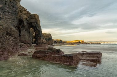 Kuzey İspanya 'daki Galiçya' daki Playa de las Catedrales Plajı 'nda güzel bir gün doğumu.