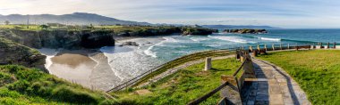 A view of the coast and beaches near Playa de Catedrales in Galicia clipart