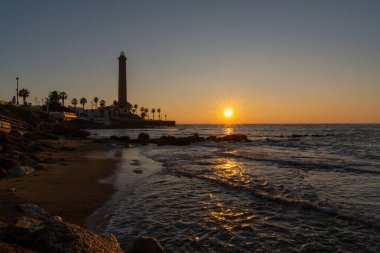 A horizontal view of the Chipiona lighthouse in Andalusia at sunset clipart