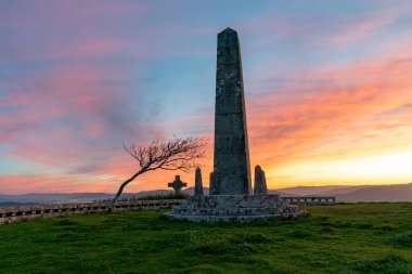 Güneşin doğuşunda Galiçya 'da Santa Tecla' nın tepesinde bir dikilitaş dikeni