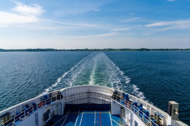 view of the open ocean with the wake of a large passenger ferry clipart