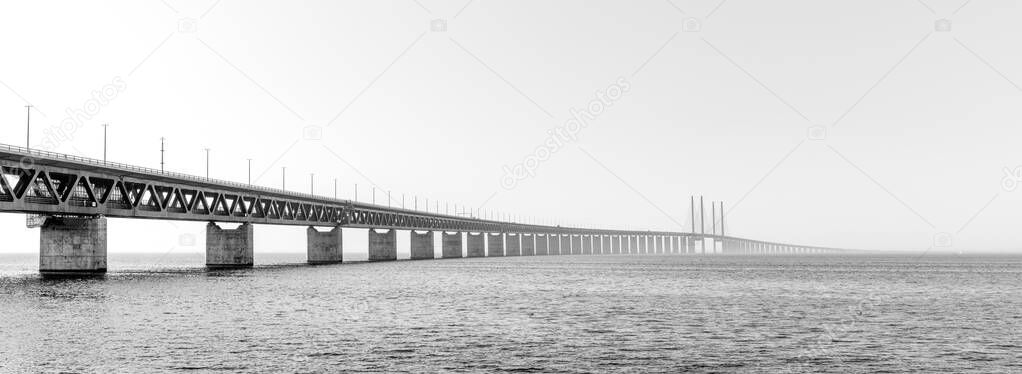 A black and white panorama view of the Oresund Bridge between Denmark and Sweden