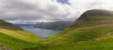 Faroe Adaları 'nın dağlık kesimlerine giden bir dağ yolu olan Funningur' un fiyort ve köyünün manzarası.