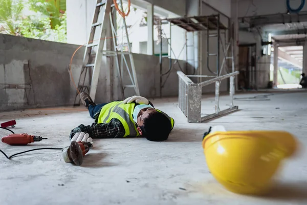 Work accidents of worker in the workplace at construction site area, Builder accident falls ladder on floor and Unconscious, Electric suction, Unsafe concept. Add zoom filter effect for feelings.