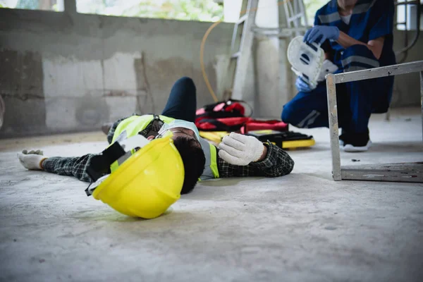 Work accidents of worker in the workplace at construction site area, Builder accident falls ladder on floor and Unconscious, Electric suction, Unsafe concept.