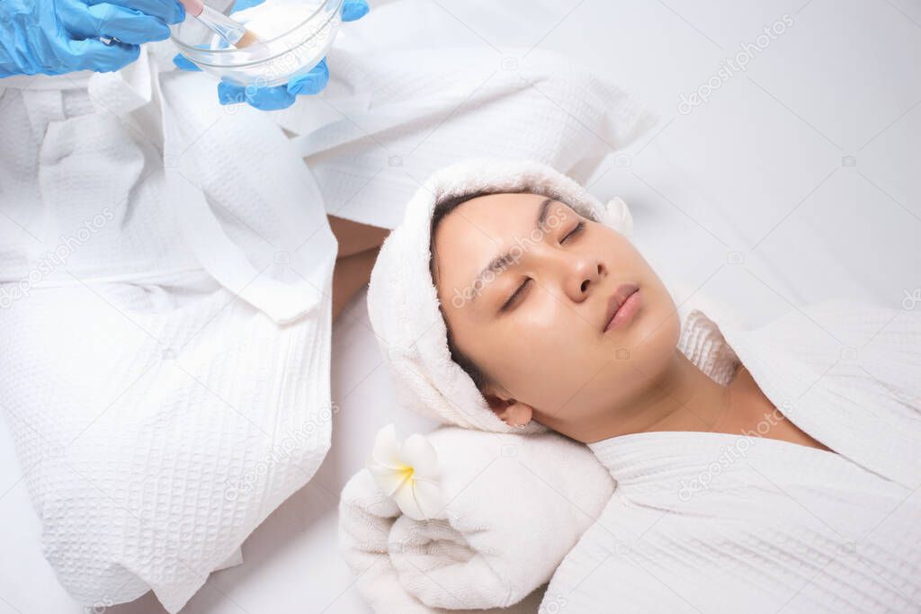 Young Asian Women with clean face prepare to get facial care, Facial masks, and spa beauty treatment for soft smooth silky skin. Beauty skincare concept