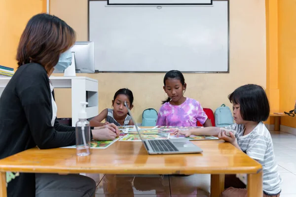 Группа Азиатских Маленьких Девочек Сидящих Столом Отрабатывает Свои Навыки Концентрируется — стоковое фото
