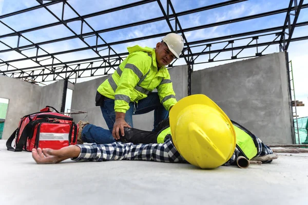 İnşaat işçisinin iş yerinde bir kaza. İnşaat kazasında bina iskelesi çöktü, ilk yardım ekibi acil müdahale için içeri girdi ve çalışan kazasına yardım etti. İş konseptinde güvenlik.