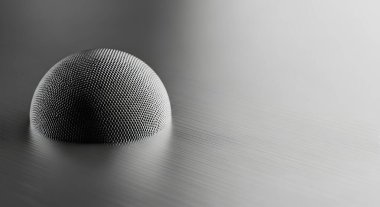 Parlak bir yüzey üzerinde dinlenen dokulu bir kürenin yakından, tek renkli görüntüsü, minimalist ve fütürist bir estetik yaratıyor..