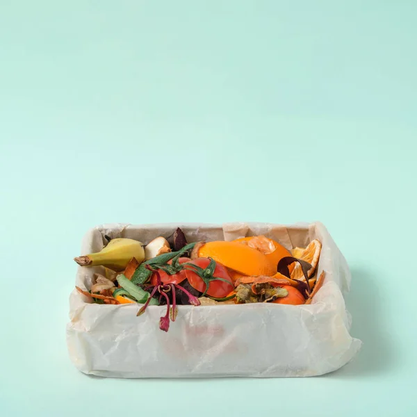 compost, food leftovers, vegetable peels in compost bin on blue background. Copy space, Sustainable and zero waste