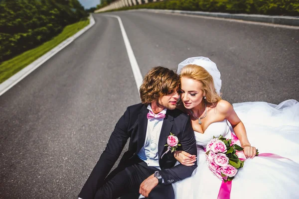 Wedding couple sitting on ground — Stock Photo, Image