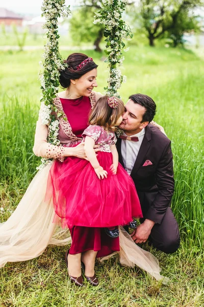 Famiglia in posa su un'altalena — Foto Stock