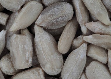 Sunflower seeds covered in frost, displayed in a close-up shot. They are ready for processing or can be enjoyed as a healthy snack. Perfect for a nutritious diet or cooking