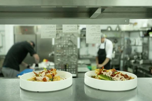 Restaurant Kitchen, behind the scenes, dinner\'s ready to eat, chefs on background