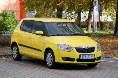 Ostrava, Czechia - October 19, 2025: Yellow Skoda Fabia II hatchback vehicle parked on street