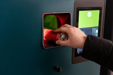 İnsan eli makineye plastik şişe koyar. Müşteriler biberonlarını ve kutularını geri veriyorlar. Yüksek kalite fotoğraf Kaucja