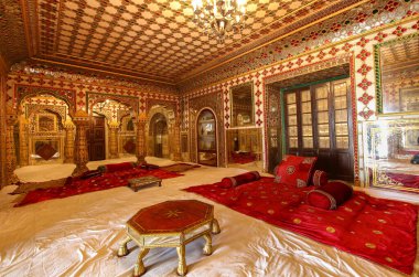 Ancient royal room with precious gems and gold carvings at City Palace Jaipur.