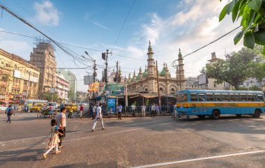 Kolkata, Hindistan, 14 Mart 2021: Eski cami ve Hindistan 'ın Korkata bölgesindeki ofis binaları manzaralı şehir yolu kavşağındaki insanlar