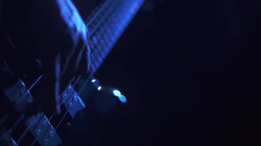 Bass player performing in blue light and slow motion