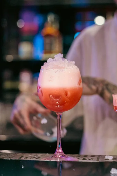 Gece hayatı, kokteyl kültürü ve konukseverlik kavramları için mükemmel köpük ve narenciye dolu kırmızı bir kokteylin yakın çekimi. Bar 'daki Stemed Glass' te Kırmızı Kokteyl.
