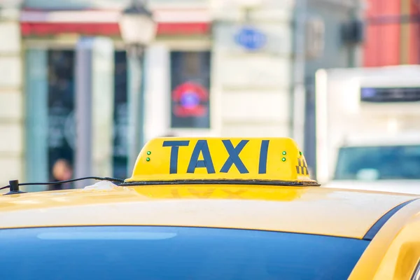 Yellow taxi sign. Taxi car on the street