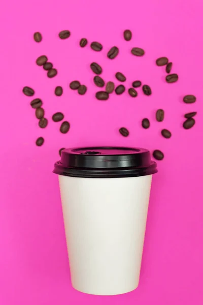 coffee to go paper cup on neon pink bright background. Eco concept.