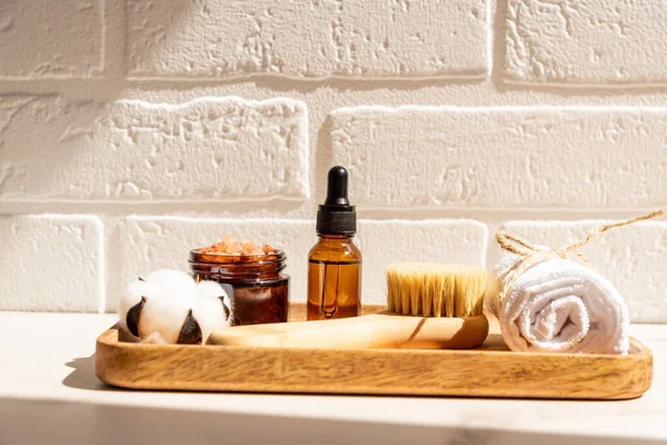 Natural organic SPA beauty products set on wooden tray on white background. Sustainable lifestyle concept.