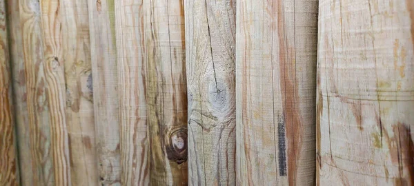 A fence made of round logs in the near horizontal frame