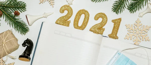 gifts for Christmas banner . Open blank notebook to record wishes and wish list for New Year's Eve, gift packaged in eco-friendly paper from recycled waste. chess pieces, a plan for a chess player's year