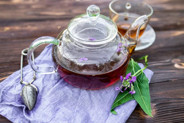 cup of herbal tea with fresh leaves and flowers Matthiola incana, Brompton stock, common stock, hoary stock, ten-week stock, and gilly-flower tea with fresh quotes, which can give an antiseptic effect