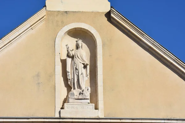 statue of Mary raising her arm pediment Our Lady of Good Help