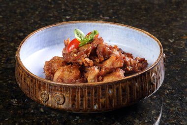 Karaage, Japanese fried chicken with boneless chicken thigh, garlic cloves, ginger, scallions, lemon, cornstarch, dry sake, soy sauce, salt and pepper to taste.