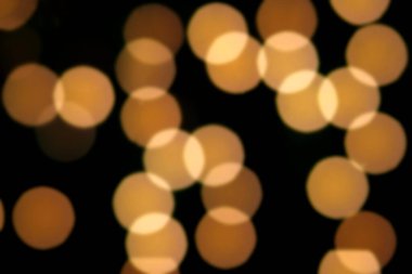 Siyah arkaplandaki renkli ve bulanık ışıkların dokusu.