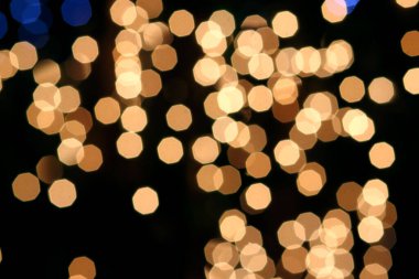 Siyah arkaplandaki renkli ve bulanık ışıkların dokusu.