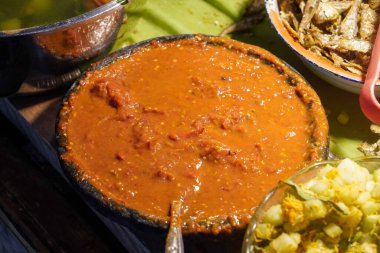 Endonezya yemekleri, canlı ev yapımı tatlar, karışık sebzeler, kızarmış balık, lezzetli mezeler, ve kırsal pazar tarzı sunum, iştah açıcı dokulara sahip zengin kültürel mutfak görselleri.