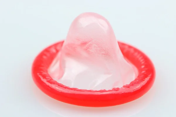 One single red condom for have safer sex — Stock Photo, Image