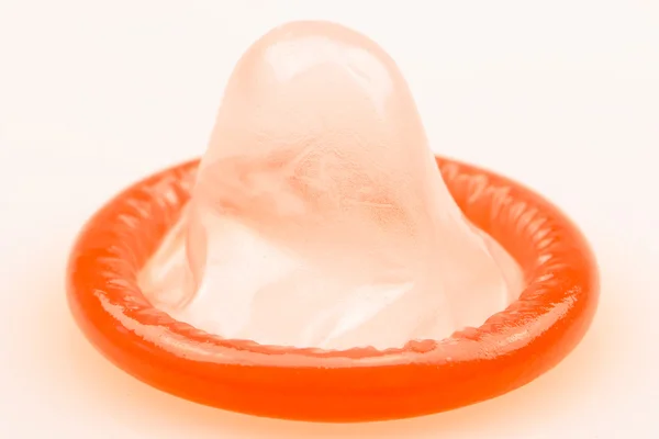 One single red condom for have safer sex - Stock-foto