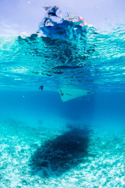 Shadow of diving boat