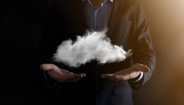 Businessman hand holding cloud.Cloud computing concept, close up of young business man with cloud over his hand.The concept of cloud service