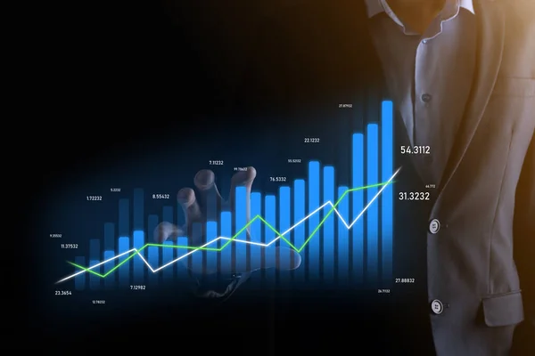 Business man holding holographic graphs and stock market statistics gain profits. Concept of growth planning and business strategy. Display of good economy form digital screen