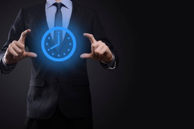 İş adamı, saatin simgesini okla tutar. İşlerin hızlı yürütülmesi. İş zamanı yönetimi ve iş zamanı para kavramlarıdır..