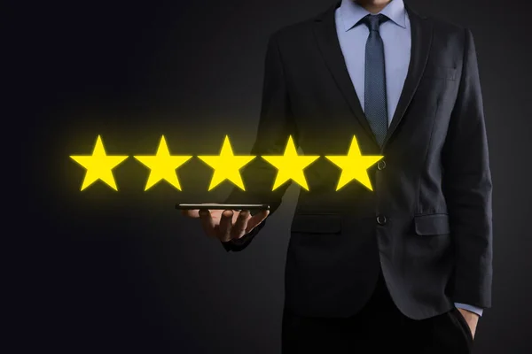 Man hand showing on five star excellent rating.pointing five star symbol to increase rating of company.Review, increase rating or ranking, evaluation and classification concept.