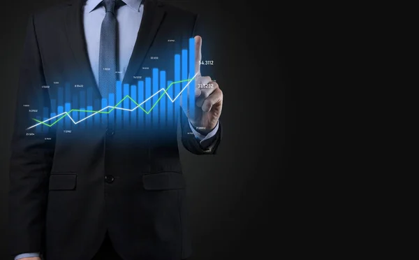 Business man holding holographic graphs and stock market statistics gain profits. Concept of growth planning and business strategy. Display of good economy form digital screen