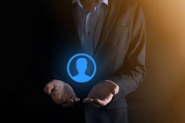 Businessman in suit holding out hand icon of user. Internet icons interface foreground. global network media concept,contact on virtual screens ,copy space.